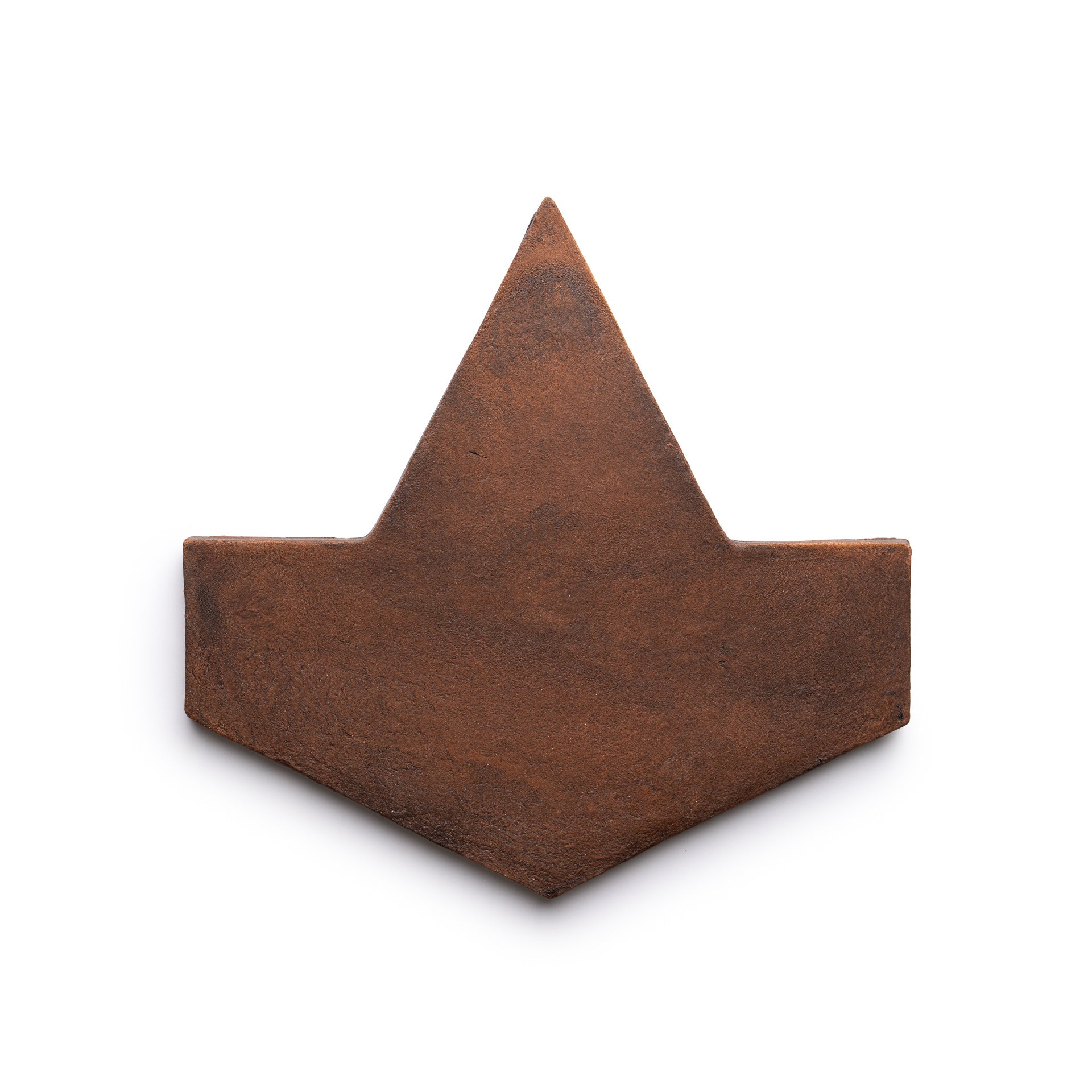 A flat, rusty brown Big Alcazar + Madera tile sample by Zia Tile, shaped like a stylized paper boat or hat and photographed on a white background.