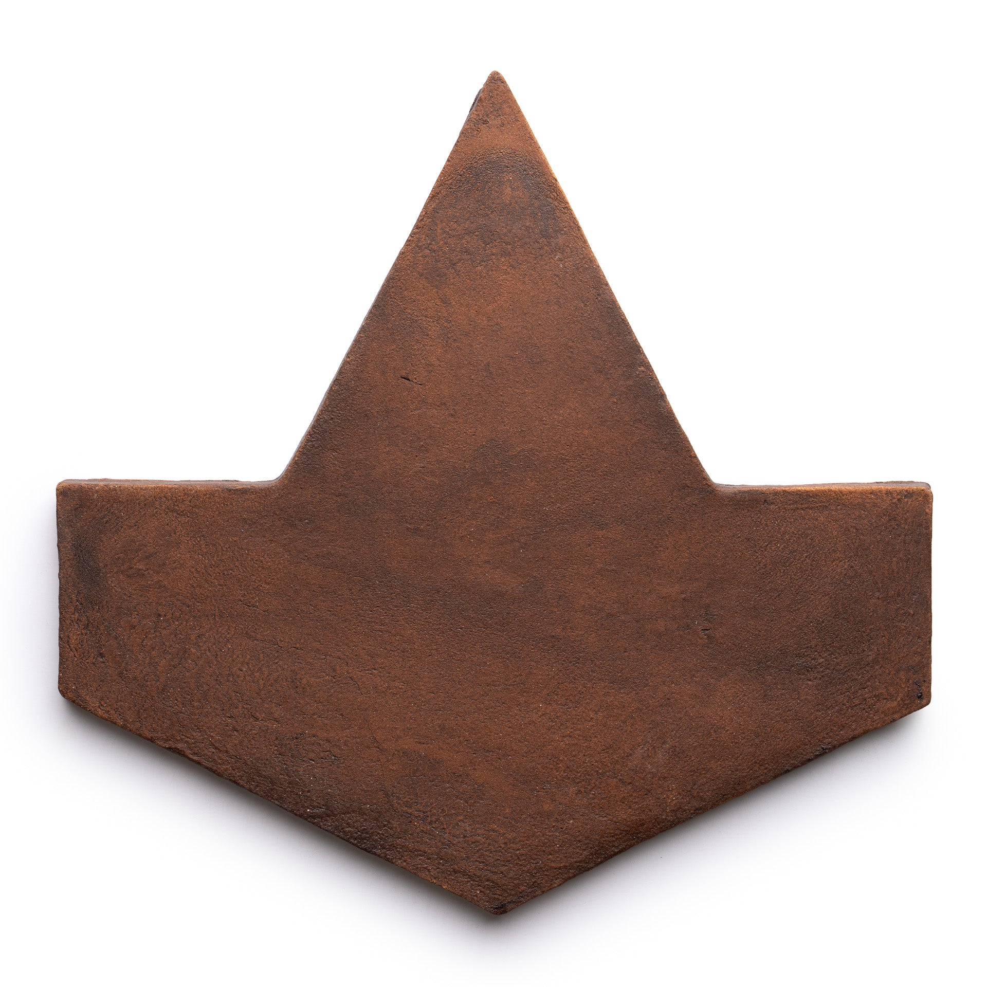 The Big Alcazar + Madera by Zia Tile is a brown, flat, geometric tile with a wide bottom, pointed top, outward corners, and a subtly textured surface resembling an origami boat or stylized crown.