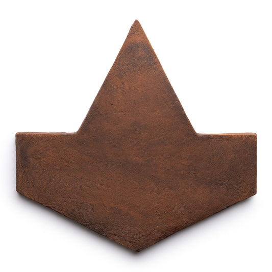 The Big Alcazar + Madera by Zia Tile is a brown, flat, geometric tile with a wide bottom, pointed top, outward corners, and a subtly textured surface resembling an origami boat or stylized crown.