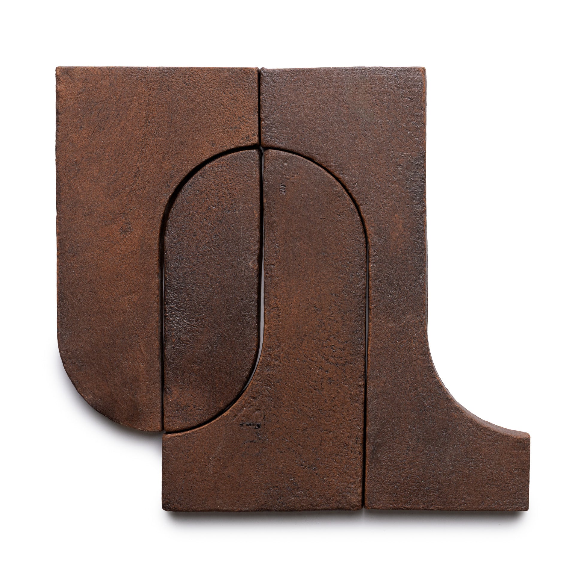 Durango + Madera by Zia Tile are two rust-colored, textured rectangular clay tiles with carved abstract geometric shapes—both rounded and straight edges—shown together on a white background.