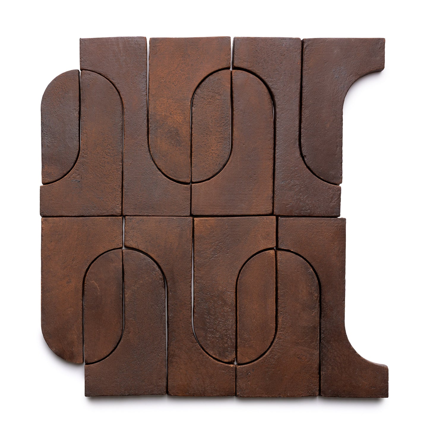 Nine brown Durango + Madera wooden blocks by Zia Tile form a square. Featuring curved and straight cutouts, they create an abstract, interlocking pattern with a modern, minimalist look.