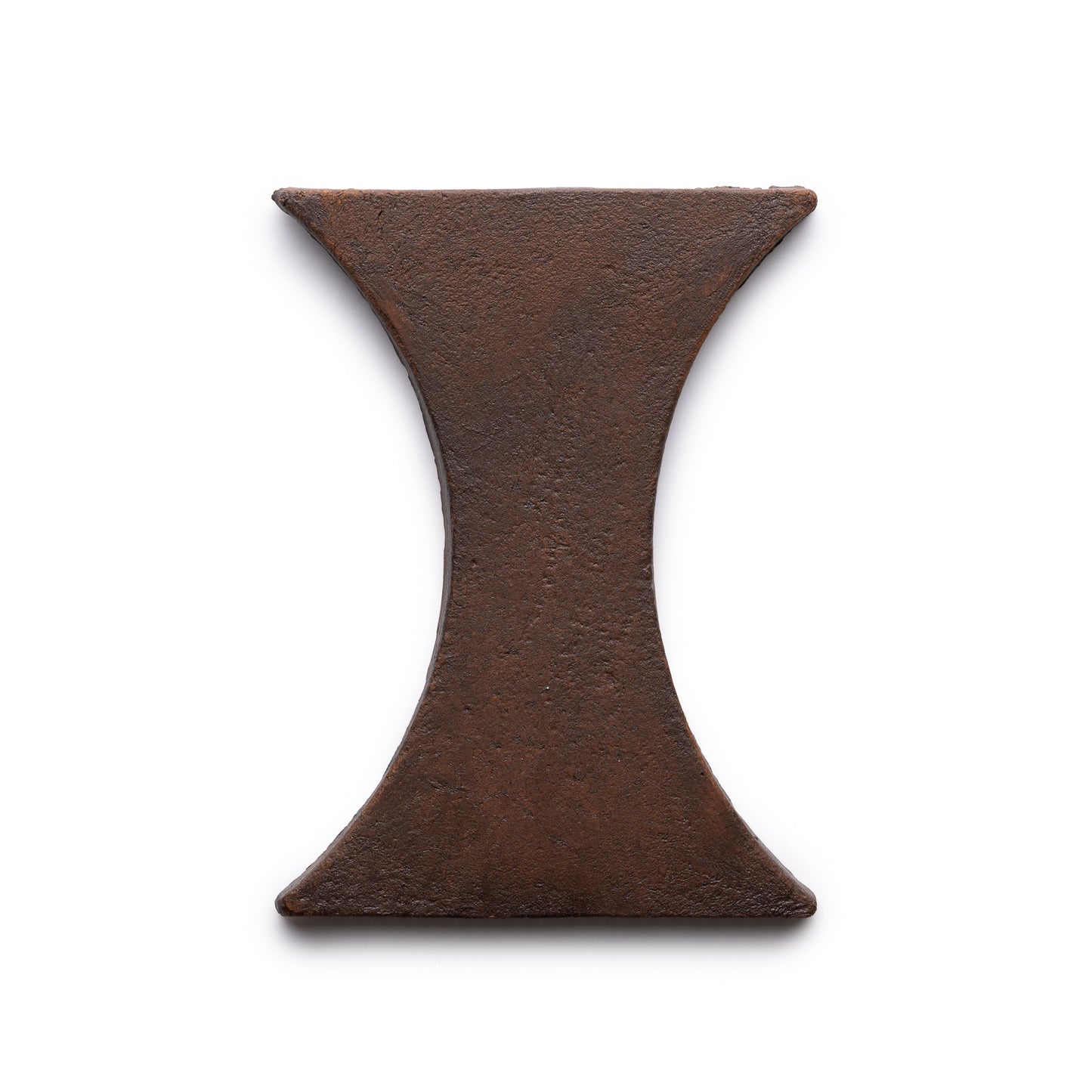 A photo of the Oaxaca + Madera tile by Zia Tile, featuring an hourglass or capital I-shaped design in rustic metal, displayed on a white background.