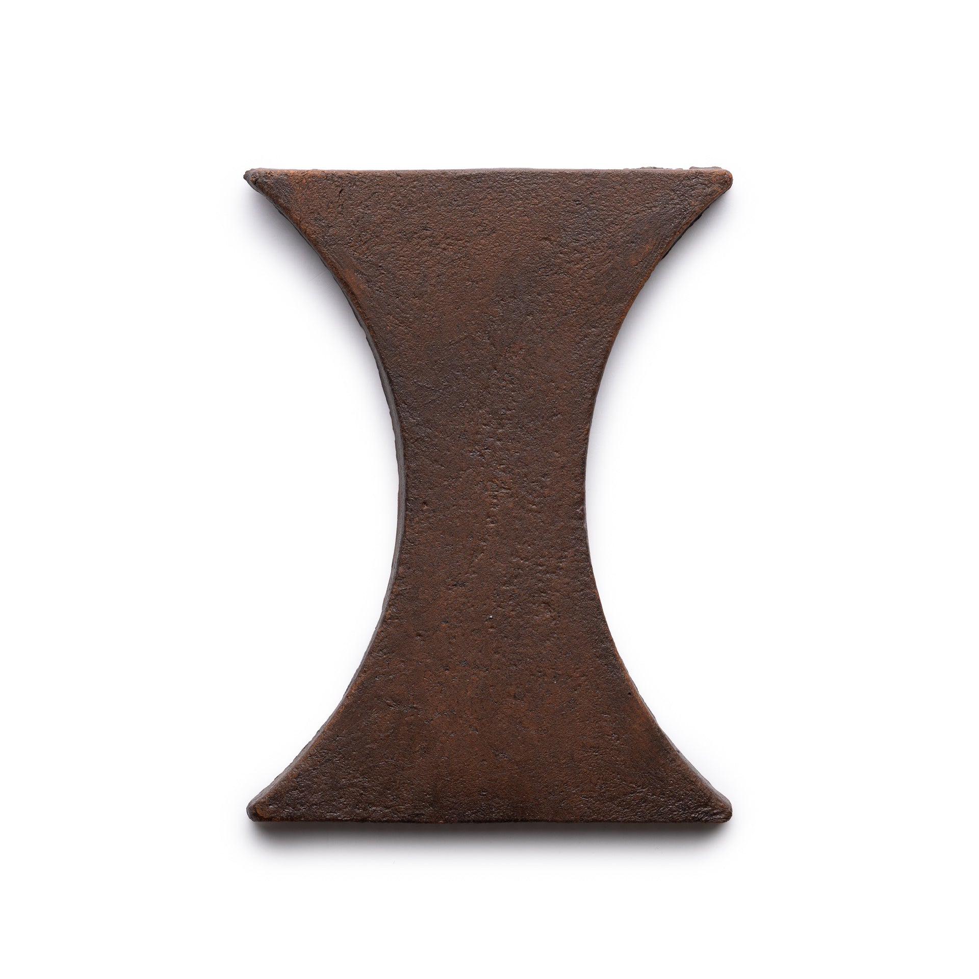 A photo of the Oaxaca + Madera tile by Zia Tile, featuring an hourglass or capital I-shaped design in rustic metal, displayed on a white background.