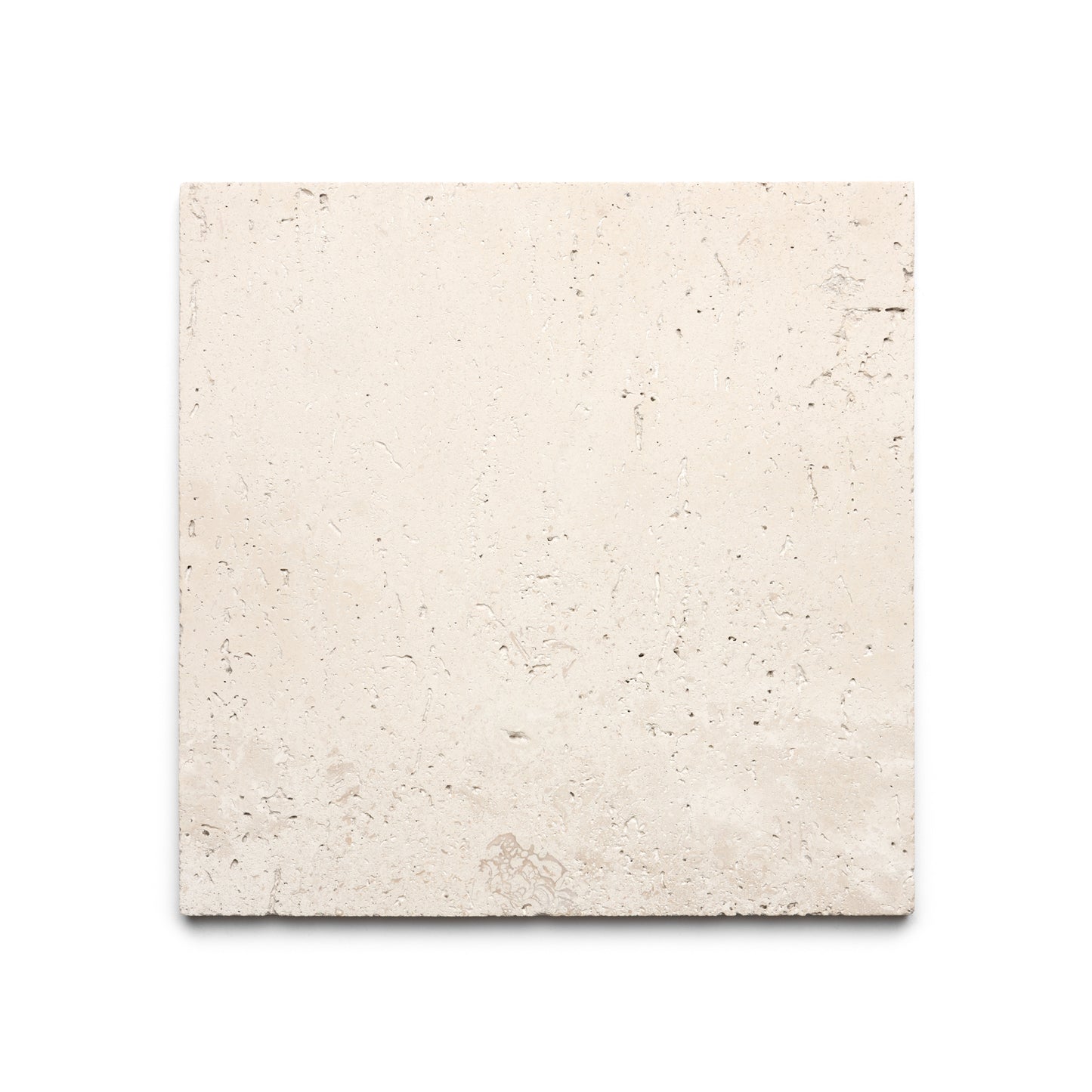 The Mesa 12x12 by Zia Tile is a square, light beige Mexican Cantera stone tile featuring a rough texture and subtle natural markings, displayed on a white background.