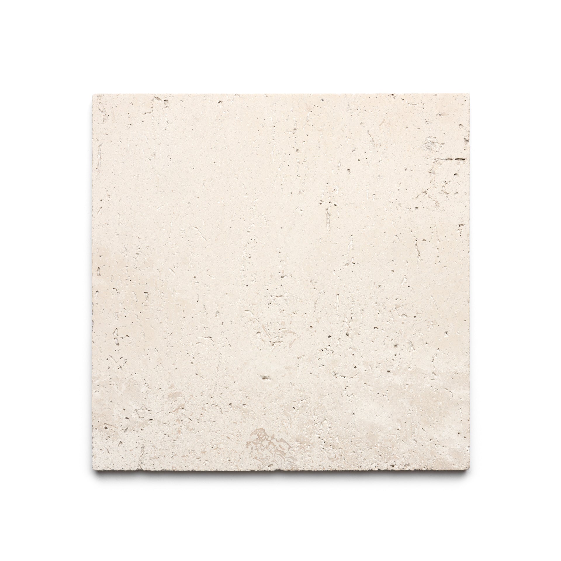 The Mesa 12x12 by Zia Tile is a square, light beige Mexican Cantera stone tile featuring a rough texture and subtle natural markings, displayed on a white background.