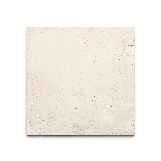The Mesa 12x12 by Zia Tile is a square, light beige Mexican Cantera stone tile featuring a rough texture and subtle natural markings, displayed on a white background.
