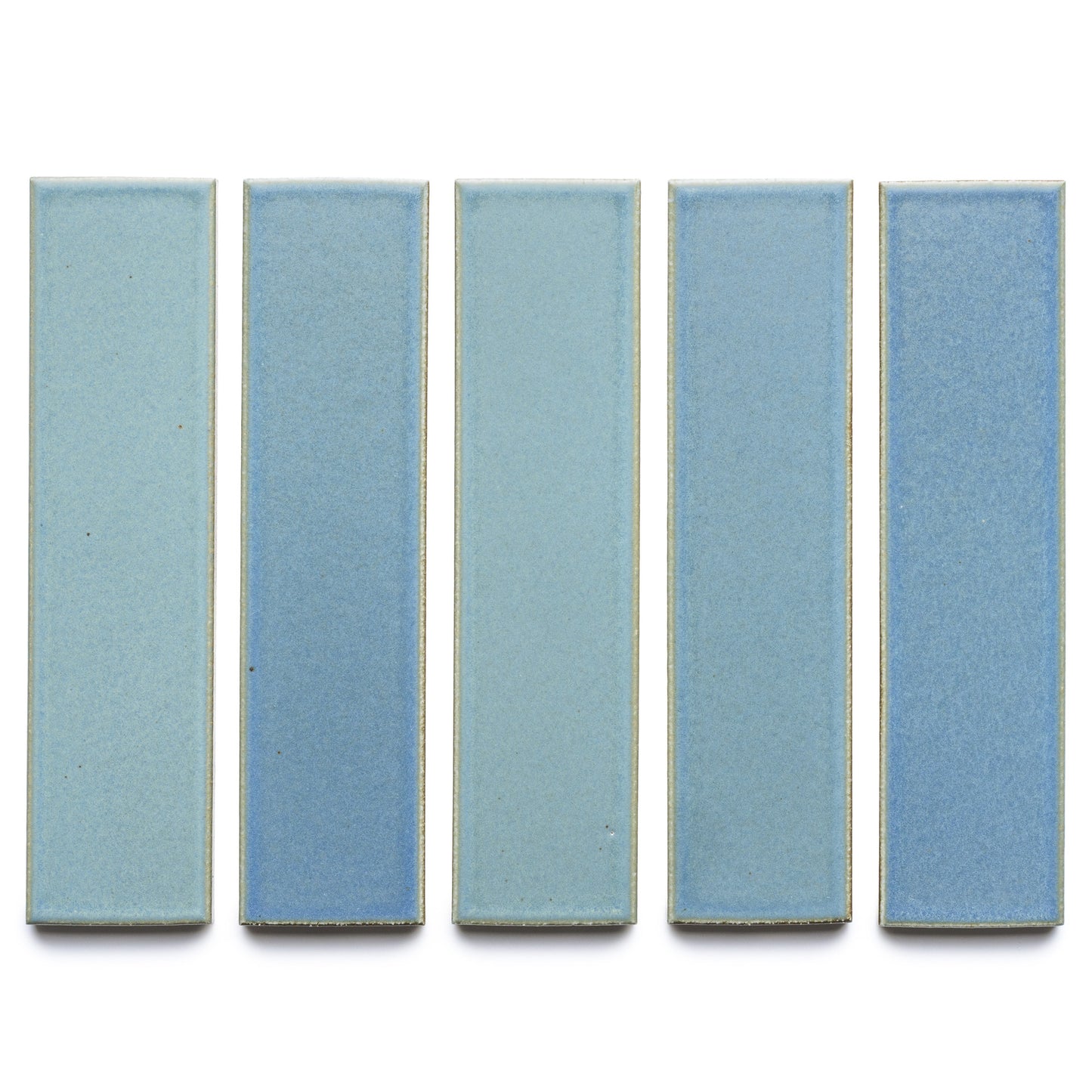 Five rectangular Morning Light + Flat tiles from Zia Tile are arranged vertically on a white background. Each light blue ceramic tile features a smooth, matte finish with subtle shade variations.