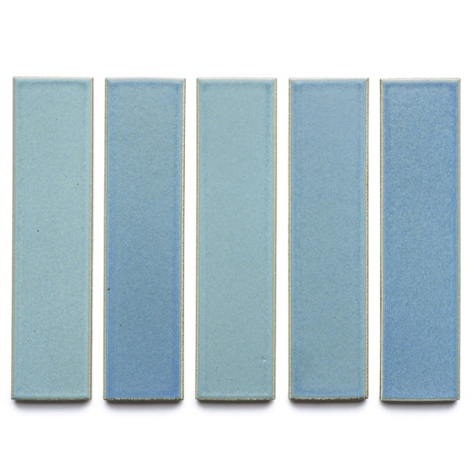 Five rectangular Morning Light + Flat tiles from Zia Tile are arranged vertically on a white background. Each light blue ceramic tile features a smooth, matte finish with subtle shade variations.