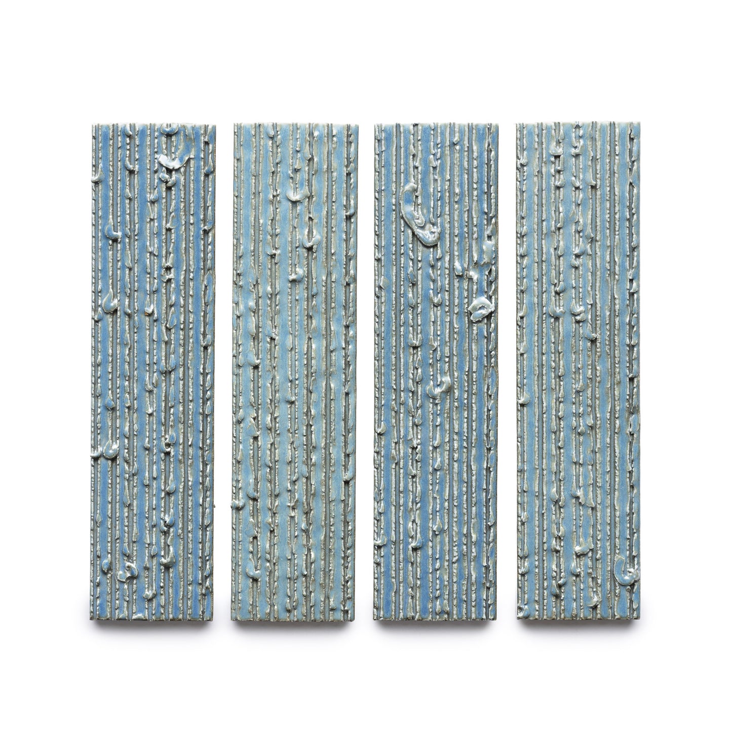 Four "Morning Light + Furrowed" rectangular blue panels by Zia Tile, featuring vertical ridges and irregular white lines, are arranged side by side against a white background.