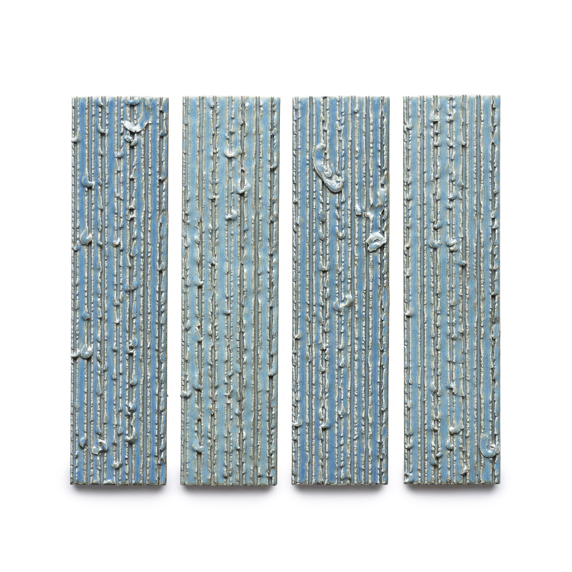 Four "Morning Light + Furrowed" rectangular blue panels by Zia Tile, featuring vertical ridges and irregular white lines, are arranged side by side against a white background.