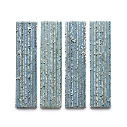 Four "Morning Light + Furrowed" rectangular blue panels by Zia Tile, featuring vertical ridges and irregular white lines, are arranged side by side against a white background.