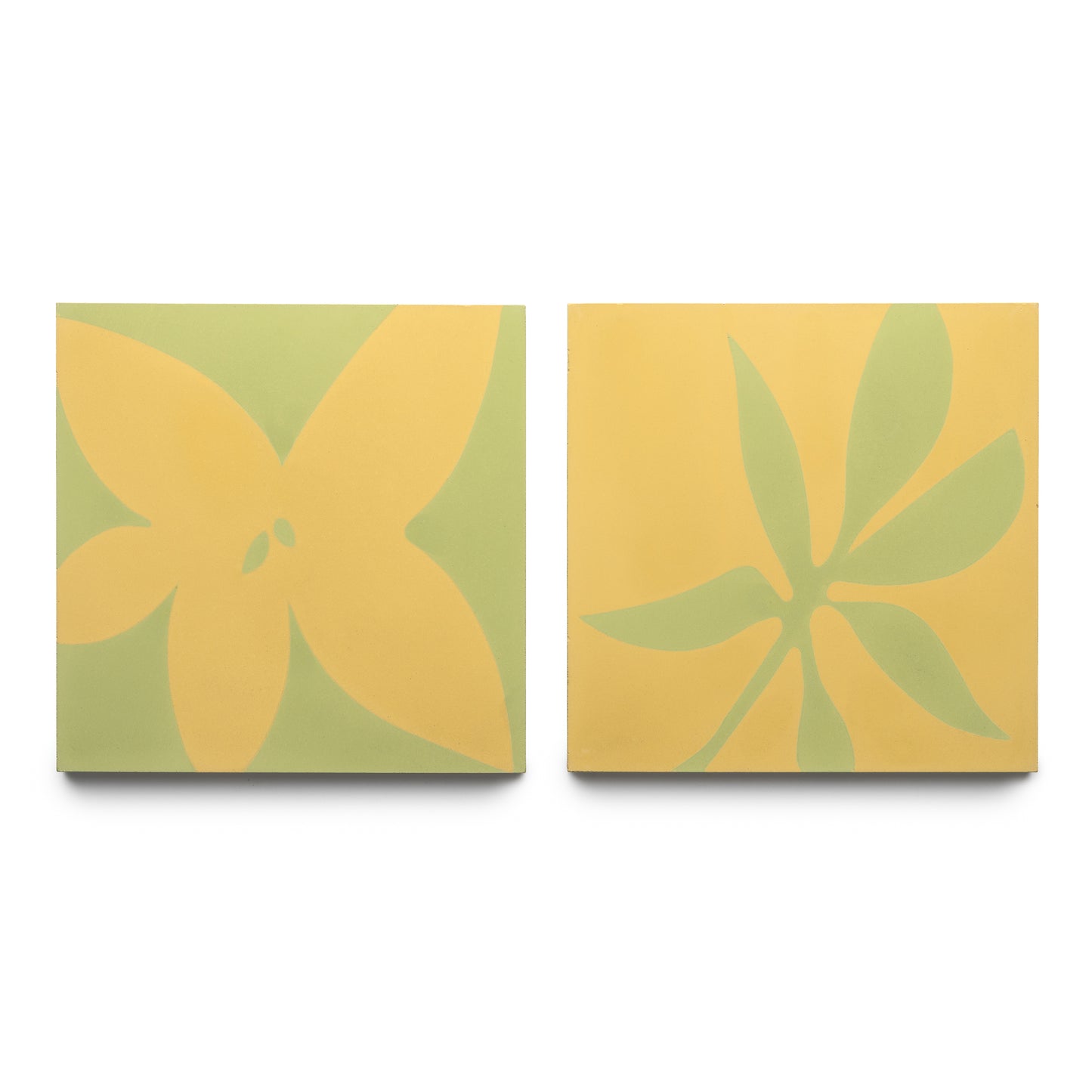The Zia Tile Flora 8x8 Set Mustard + Lemongrass features two square tiles: one with a yellow floral motif on light green, and the other with a green leafy design on mustard yellow.