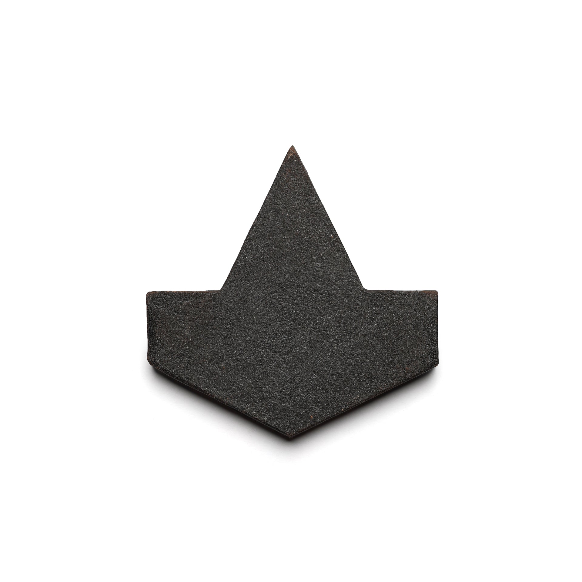 The Alcazar + Oscura by Zia Tile is a sleek black geometric tile with a central triangular peak and angled sides, inspired by minimalist paper boats and modern ceramic terra cotta design.