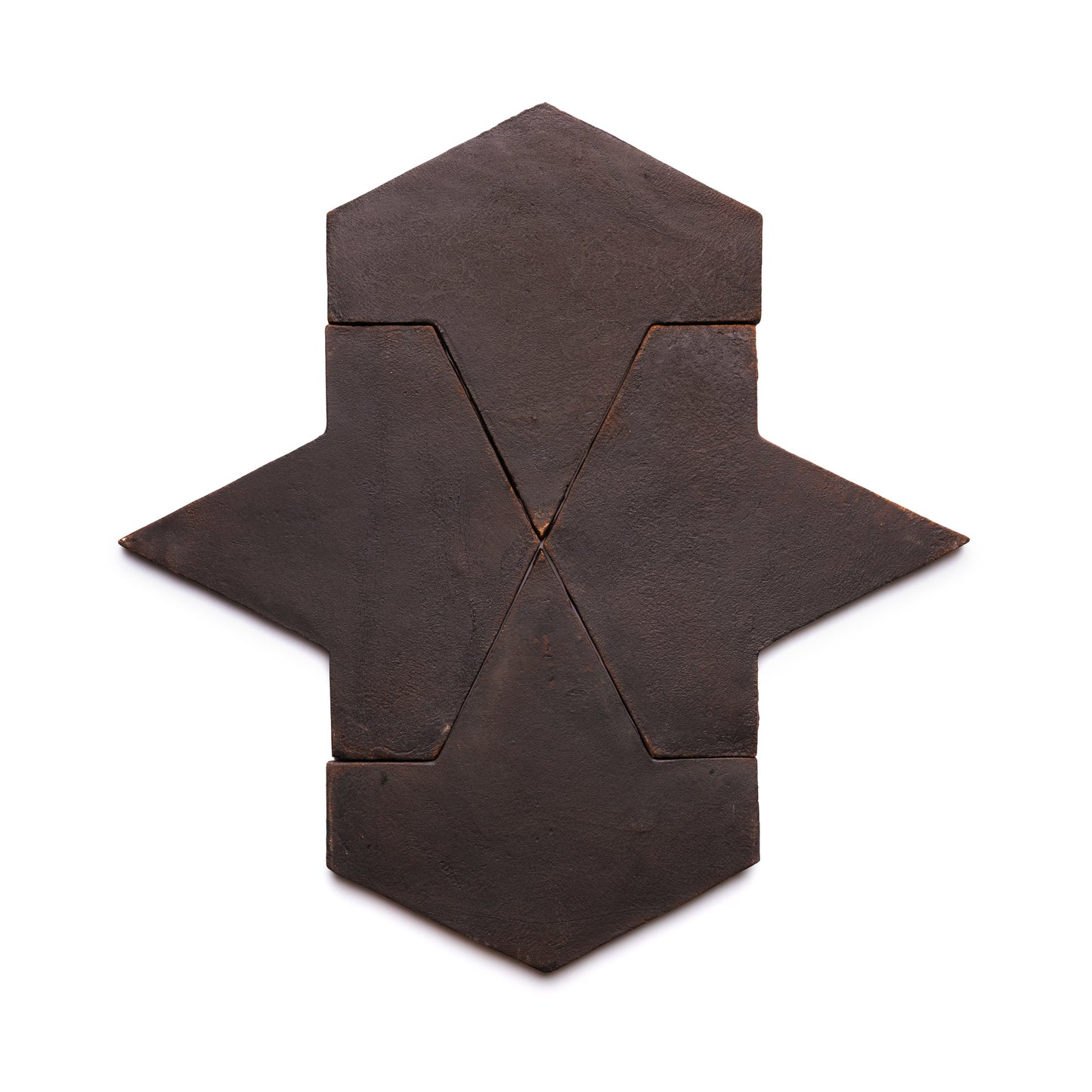 Five geometric pieces from Zia Tile’s Big Alcazar + Oscura collection are arranged in a symmetrical, abstract arrow or star shape on a white background.