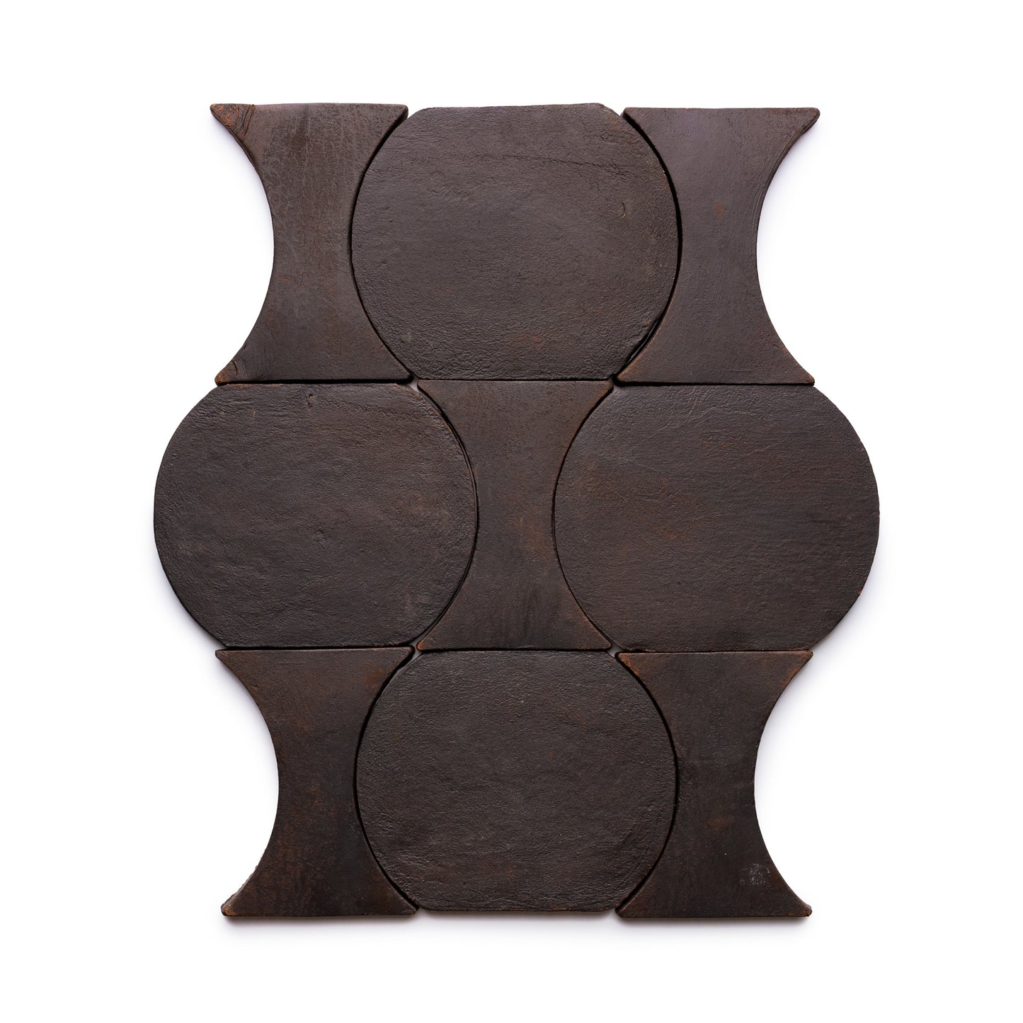 Six Oaxaca + Oscura tiles by Zia Tile are arranged in a rectangular grid, each dark brown tile featuring curved designs that form repeating circular and hourglass patterns on a white background.