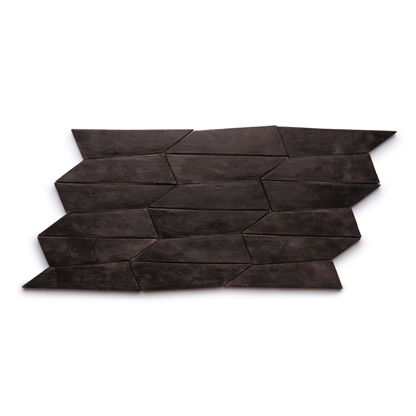 Tornillo + Oscura by Zia Tile features dark brown, trapezoid-shaped tiles in a repeating zigzag geometric pattern on a white background.