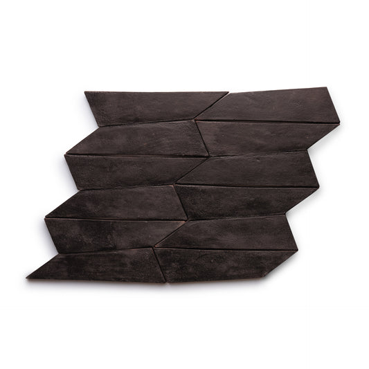 Tornillo + Oscura by Zia Tile features dark, geometric tiles set in a zigzag, staggered pattern on white, creating a bold abstract look.