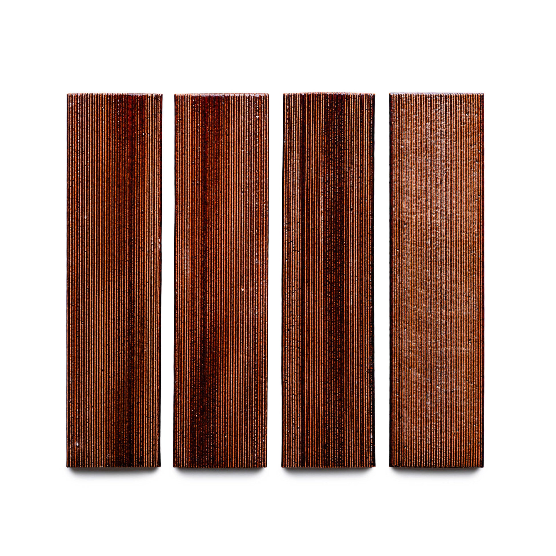 Four Oxblood + Etched rectangular wood tiles from Zia Tile, featuring vertical grain patterns, arranged side by side on a white background.