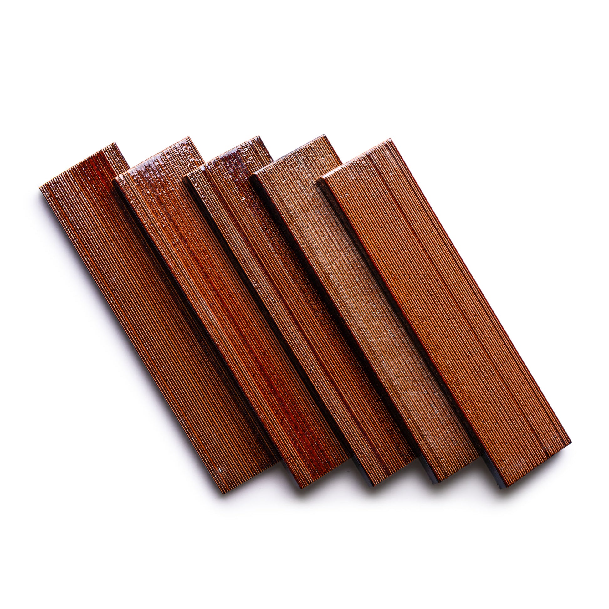 Five Oxblood + Etched wood strips by Zia Tile, each with a glossy finish and visible grain texture, are arranged diagonally on a white background.
