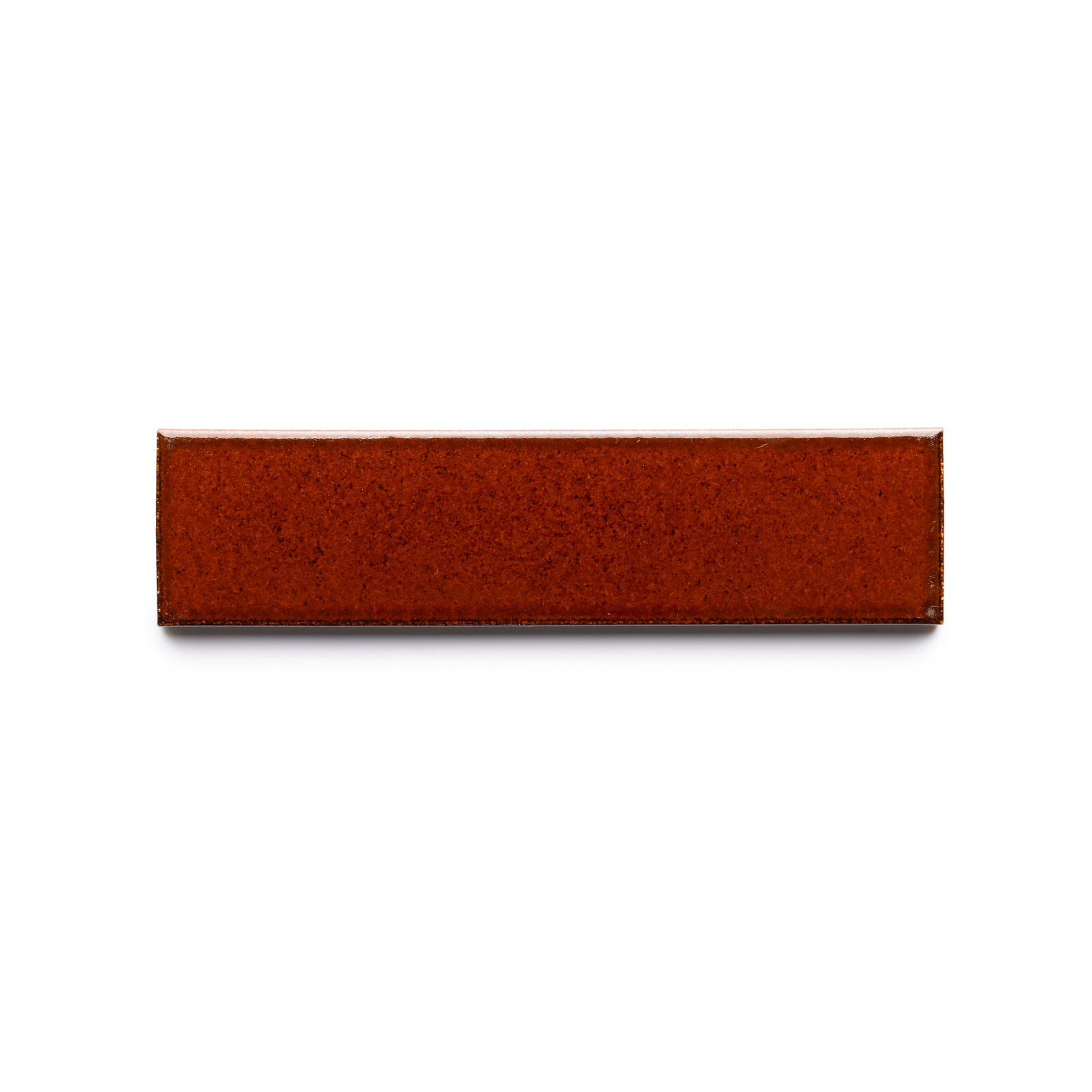 The Oxblood + Flat from Zia Tile is a rectangular, glossy, reddish-brown ceramic tile shown against a white background.