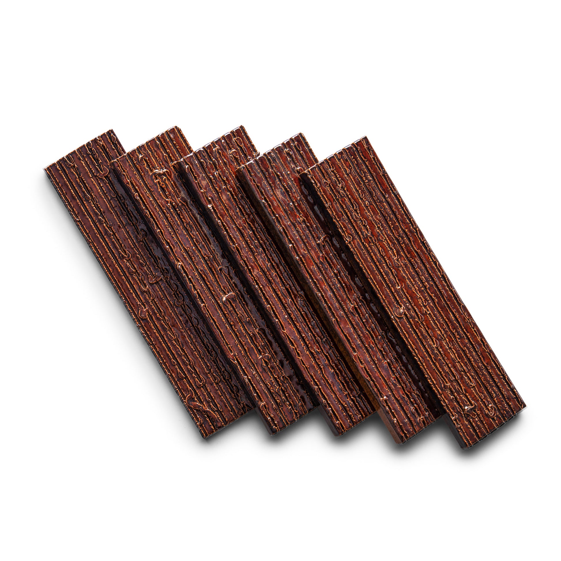 Five Oxblood + Furrowed rectangular tiles by Zia Tile are arranged diagonally on a white background, each displaying a textured surface and visible layers.