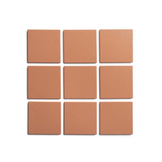 Nine Pecan 4x4 terracotta-colored square tiles from Zia Tile are arranged in a 3x3 grid on a white background, highlighting the handmade charm.