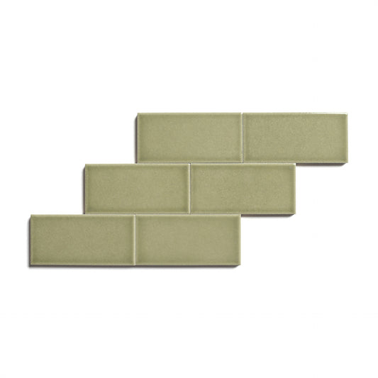 Six Ponderosa 2x4 olive-green glossy ceramic tiles from Zia Tile are arranged in a staggered, brick-like pattern against a white background.