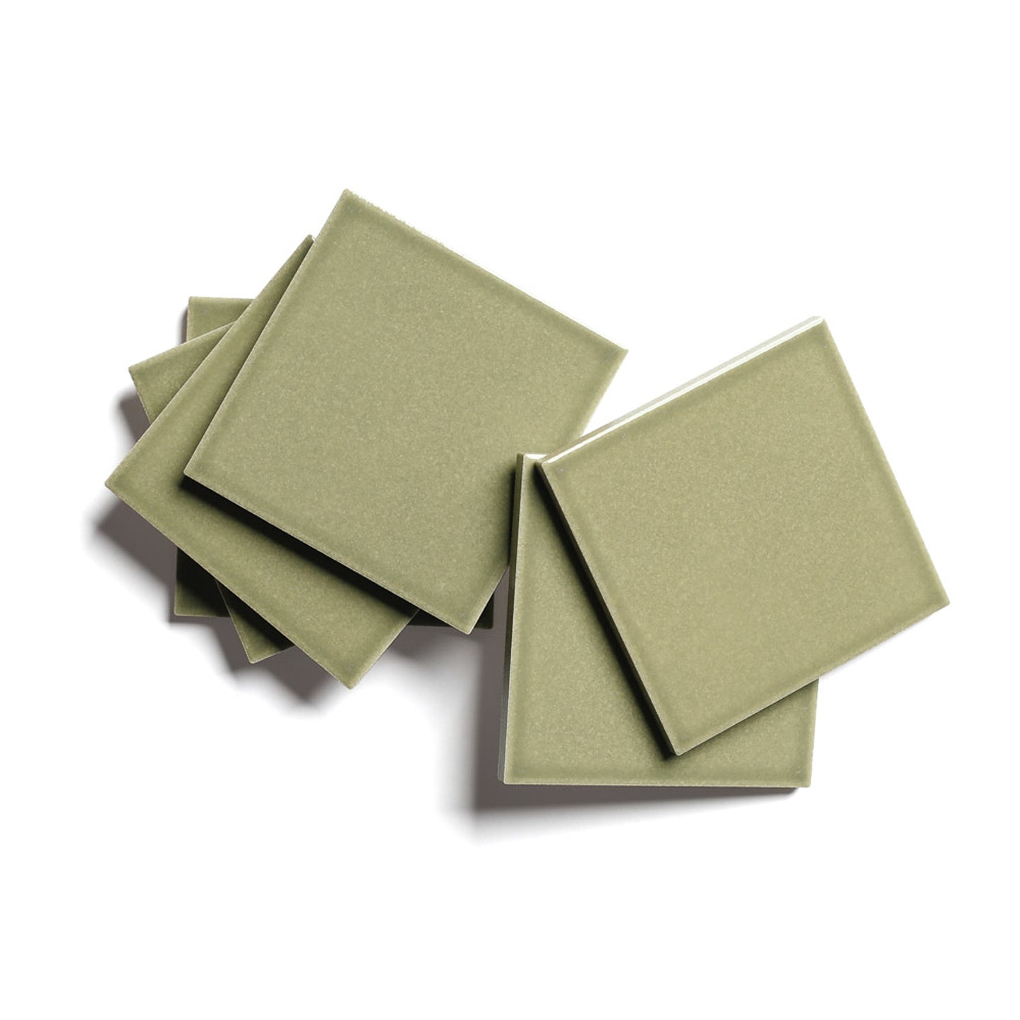 Six Ponderosa 4x4 olive-green architectural grade ceramic tiles by Zia Tile are stacked in a scattered arrangement on a white background.