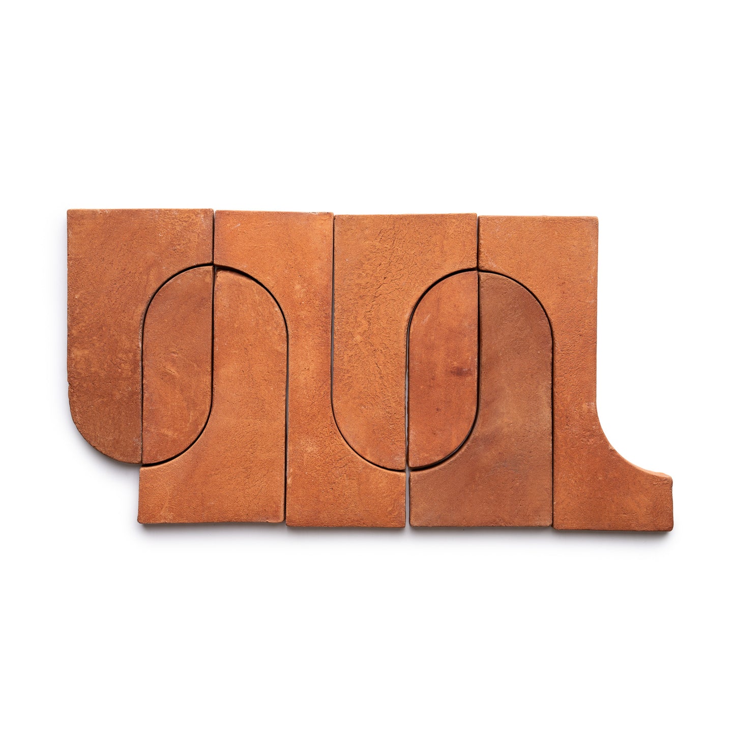 Durango + Red Clay by Zia Tile features five reddish-brown clay tiles with interlocking geometric shapes. Curved and straight edges create an abstract, symmetrical rectangular design on a white background.