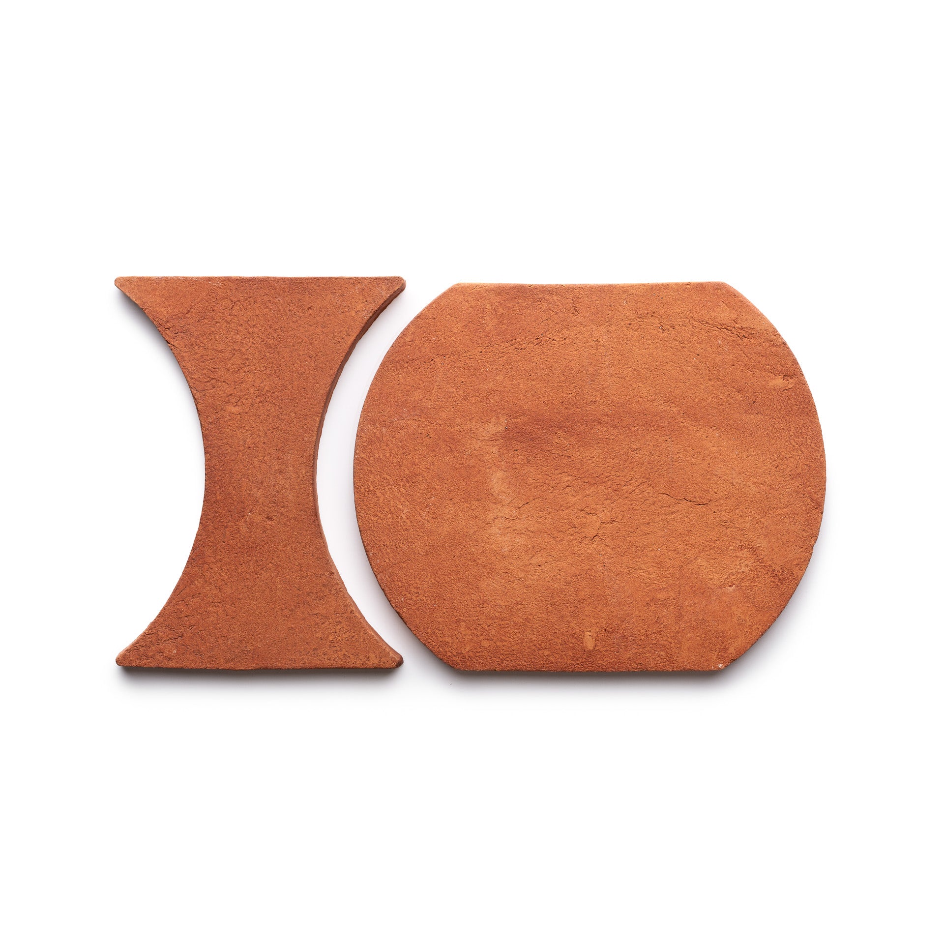 Oaxaca + Red Clay tiles by Zia Tile displayed on a white background: one is hourglass-shaped, the other a rounded square.