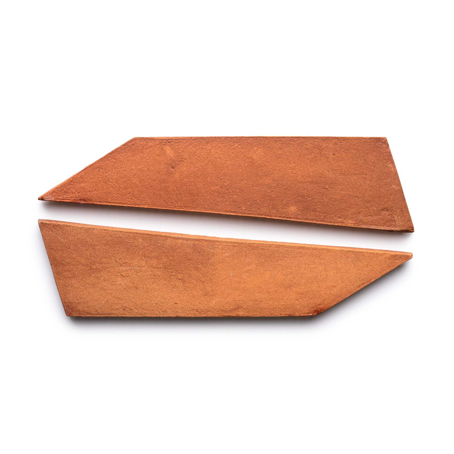Two flat, angular Tornillo + Red Clay tiles from Zia Tile with sharp, straight edges are placed parallel to each other on a white background.