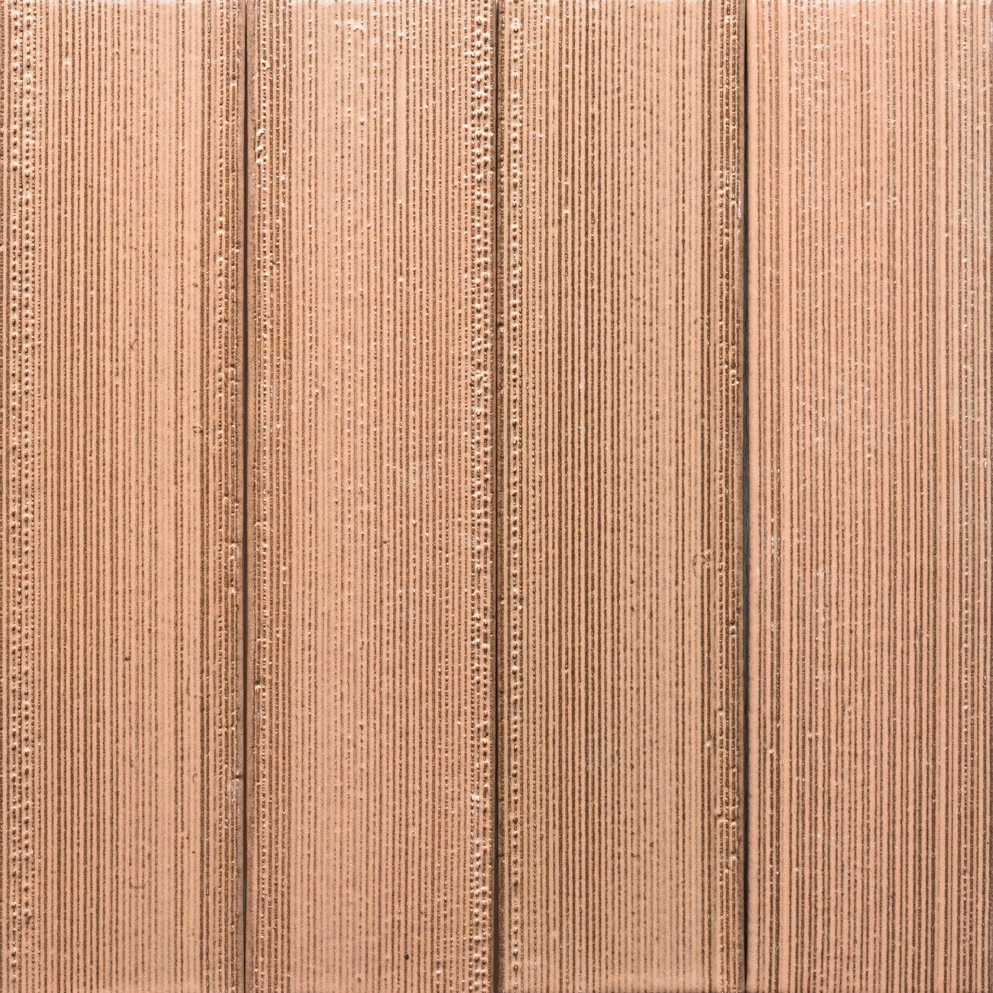 Close-up of Sakura + Etched by Zia Tile reveals its textured, light brown corrugated surface with vertical ridges and grooves in a repeating linear pattern.