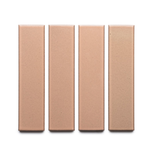 Four rectangular Sakura + Flat tiles by Zia Tile are arranged vertically on a white background. Each light brown ceramic tile features a smooth, glossy finish with subtle shade variations.