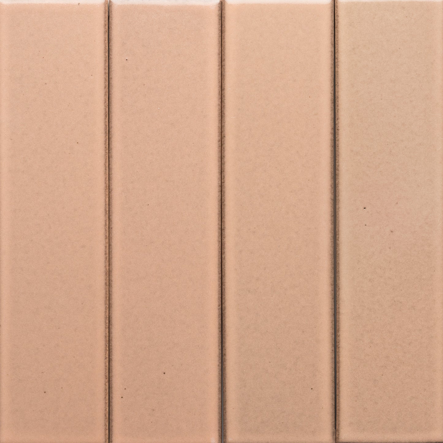 Close-up of four vertical, rectangular Sakura + Flat tiles in light brown by Zia Tile, featuring subtle grout lines that create a clean, simple geometric pattern.