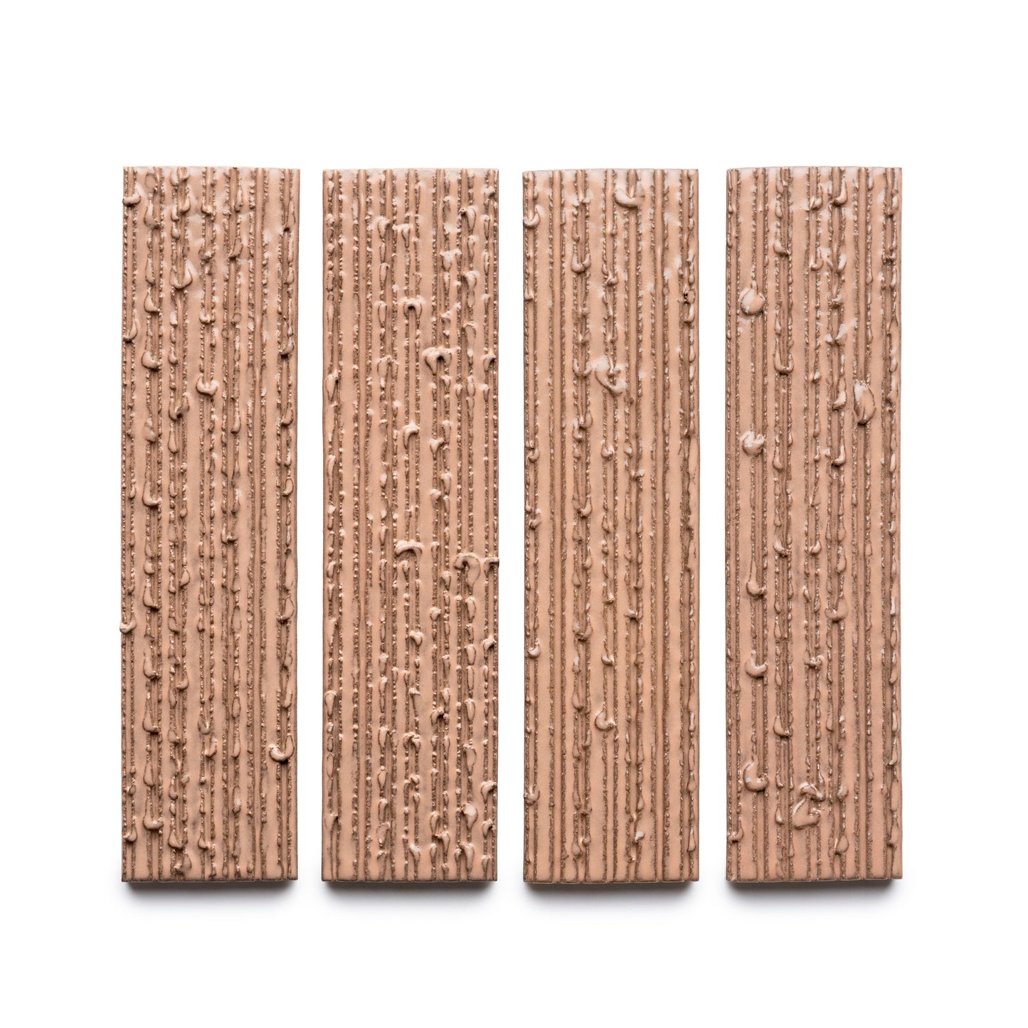 Four Sakura + Furrowed chocolate bars by Zia Tile, each rectangular with a textured surface of vertical ridges and small bumps, are arranged side by side on a white background.