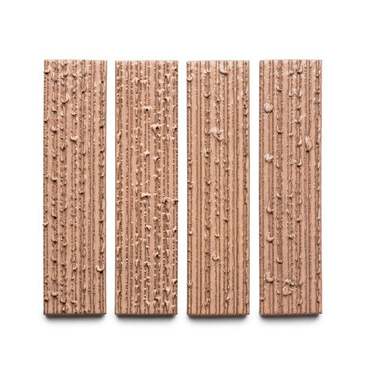 Four Sakura + Furrowed chocolate bars by Zia Tile, each rectangular with a textured surface of vertical ridges and small bumps, are arranged side by side on a white background.