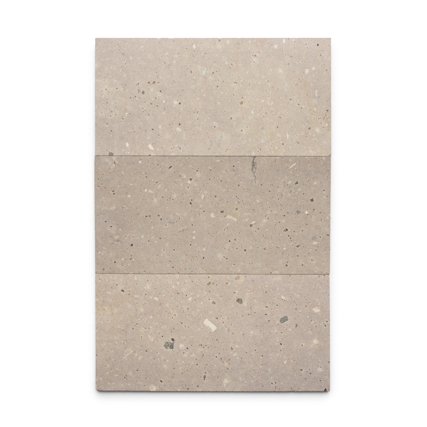 Three rectangular Sierra 12x24 tiles by Zia Tile, made of beige Mexican Cantera stone with subtle speckles and natural texture, are arranged side by side against a white background, showcasing the beauty of volcanic stone.