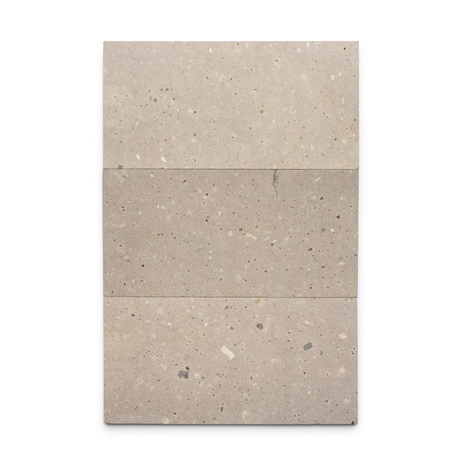 Three rectangular Sierra 12x24 tiles by Zia Tile, made of beige Mexican Cantera stone with subtle speckles and natural texture, are arranged side by side against a white background, showcasing the beauty of volcanic stone.