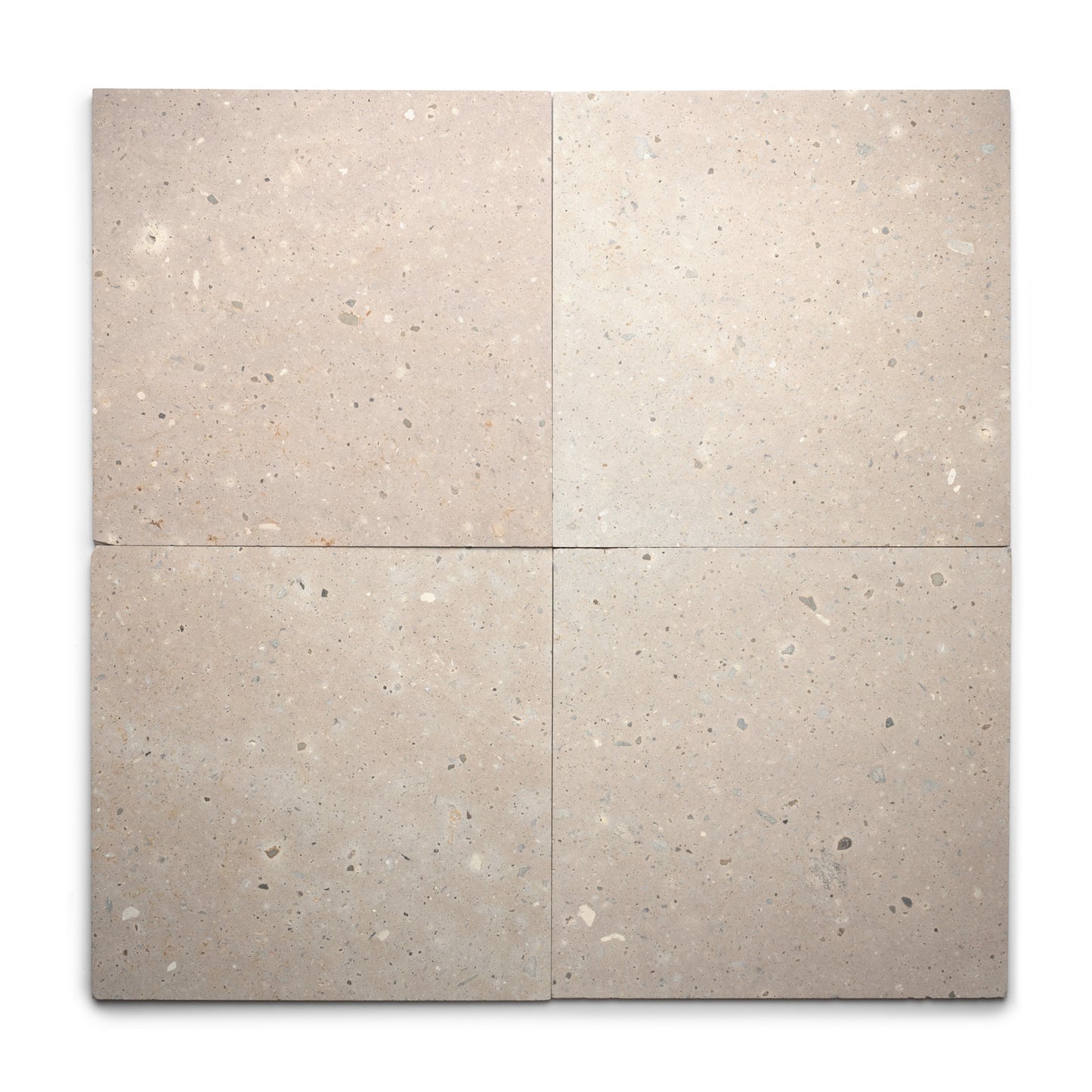 Four square Sierra 24x24 tiles by Zia Tile, in light beige Cantera stone with subtle speckling, are arranged in a grid on white. The natural volcanic stone has a slightly rough texture for an authentic appearance.