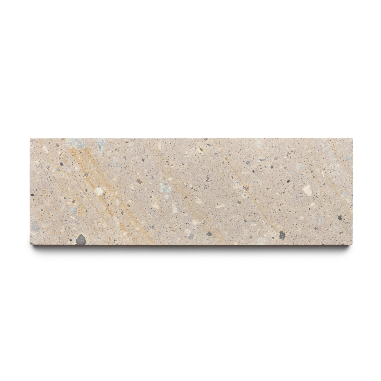 The Sierra 4x12 by Zia Tile is a rectangular beige terrazzo tile with small gray, white, and tan fragments, inspired by Mexican Cantera stone and displayed on a white background.