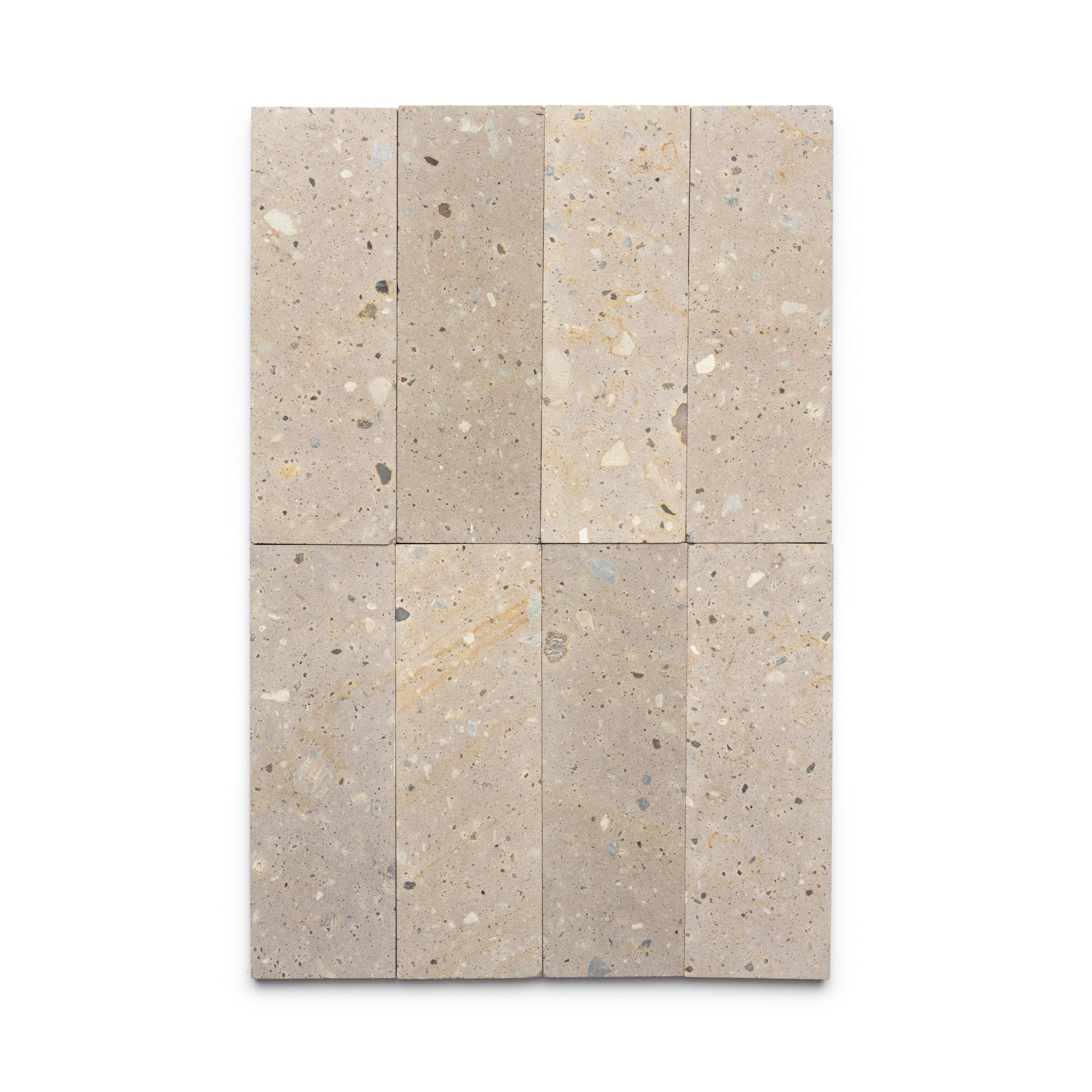 Six Sierra 4x12 tiles by Zia Tile, inspired by Mexican Cantera stone, are arranged in a 2x3 grid. Each rectangular beige tile features small, irregular gray, tan, and white specks for a natural stone texture.