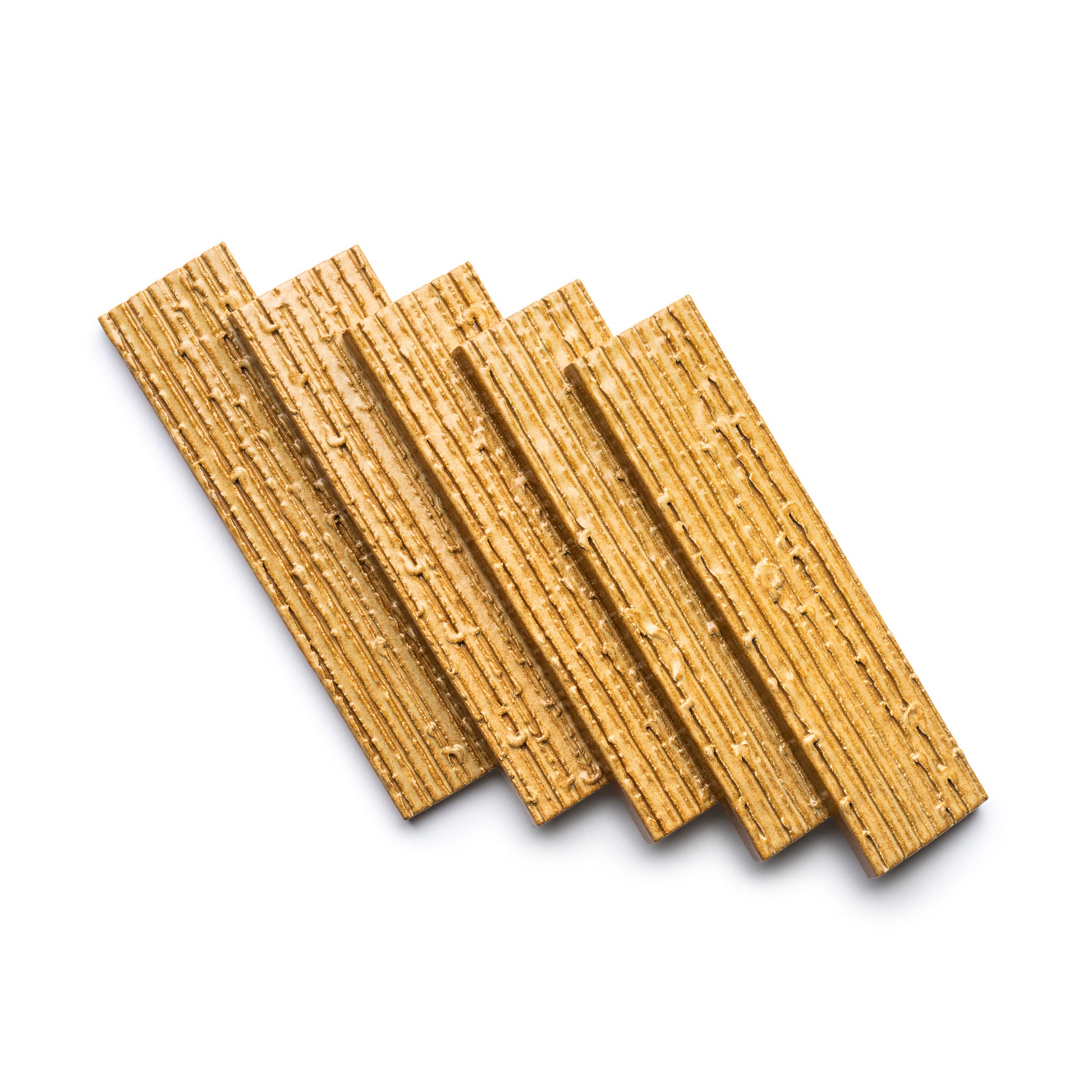 Five Toast + Furrowed rectangular wafers from Zia Tile, light golden-brown in color, are arranged in a slightly fanned-out pattern on a white background.