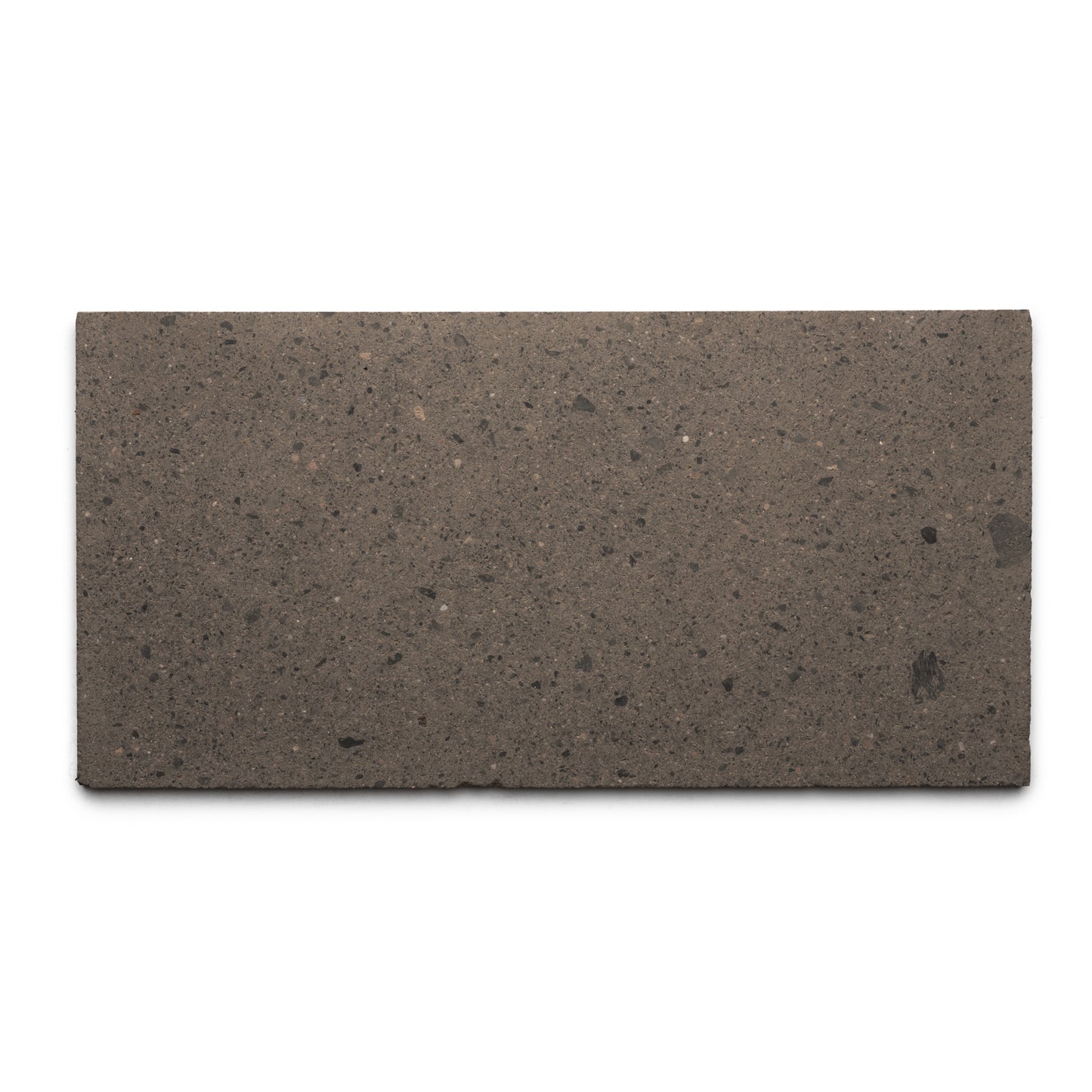 The Zia Tile Volcan 12x24 is a rectangular, flat brown tile made from natural volcanic stone with a smooth surface and subtle dark speckles, shown from above on a white background.