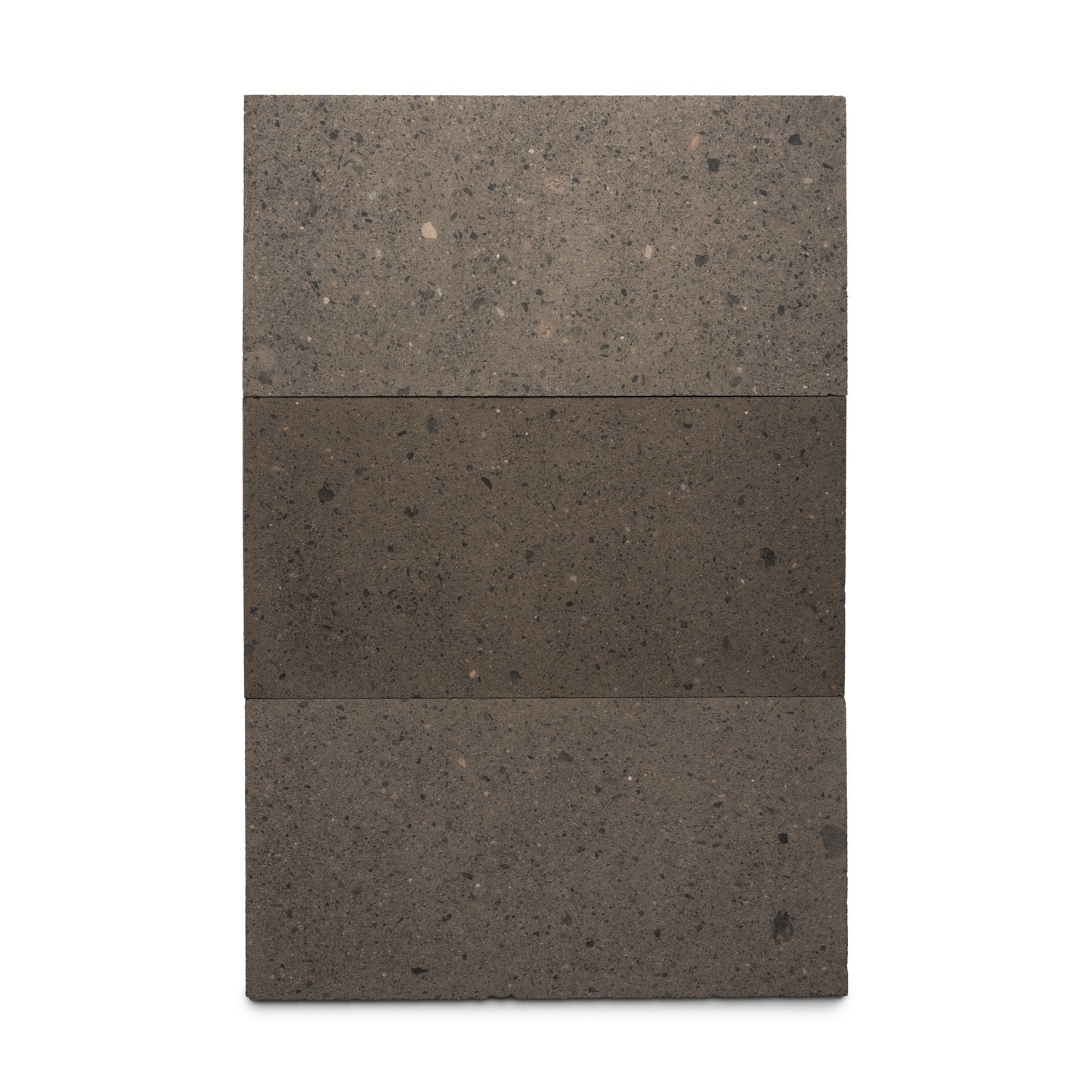 The Volcan 12x24 by Zia Tile is a rectangular, vertical slab of Mexican Cantera featuring a speckled gray texture. It's horizontally divided into three sections, with the darker middle section highlighting its natural volcanic stone look.