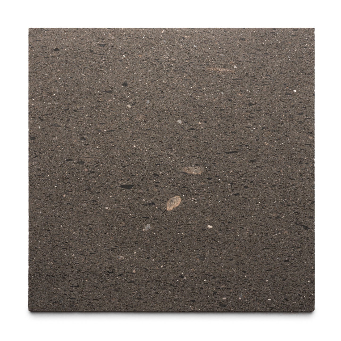 Volcan 24x24 by Zia Tile is a square slab of dark brown volcanic stone with black and light specks, showcasing authentic Mexican Cantera craftsmanship against a white background.