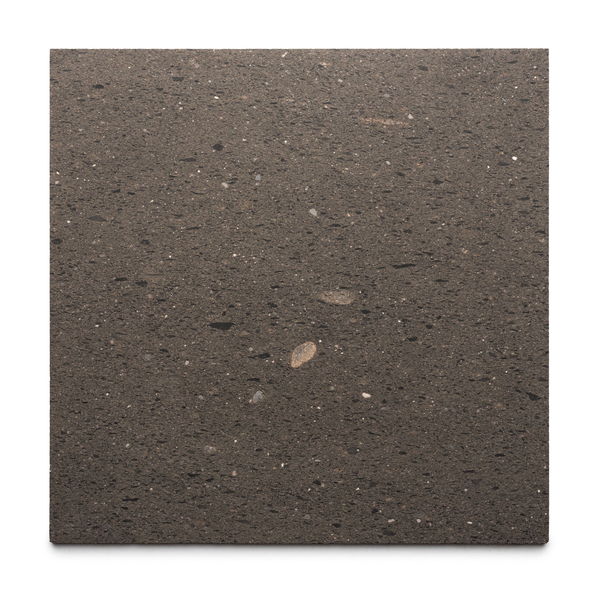 Volcan 24x24 by Zia Tile is a square slab of dark brown volcanic stone with black and light specks, showcasing authentic Mexican Cantera craftsmanship against a white background.